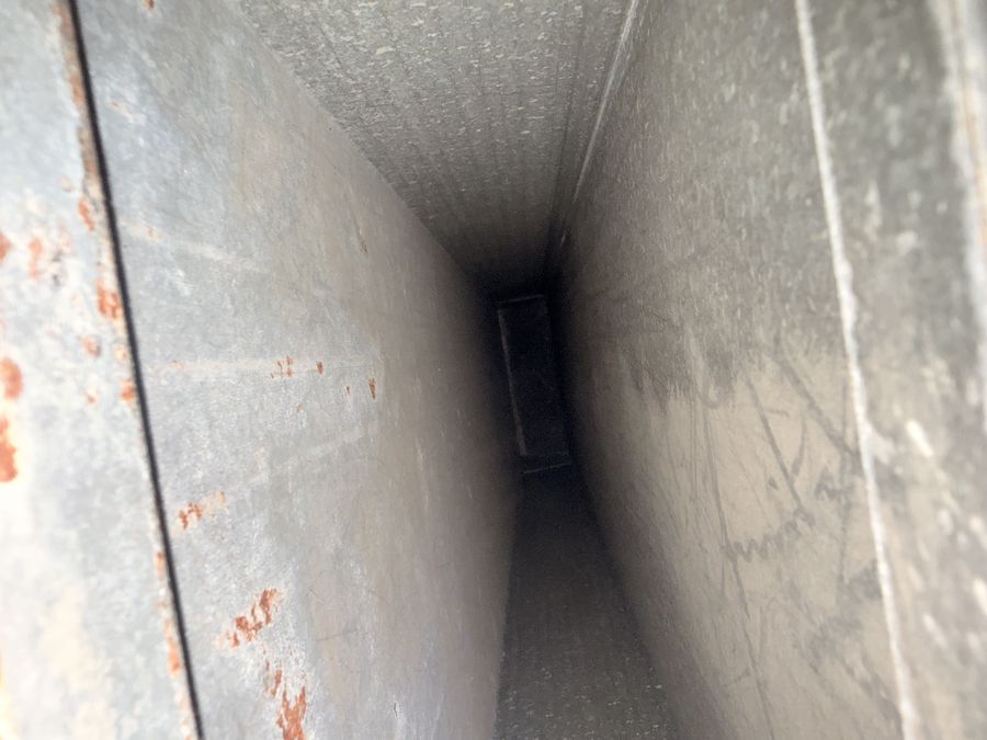 The same trunk duct after cleaning, showing bare clean metal