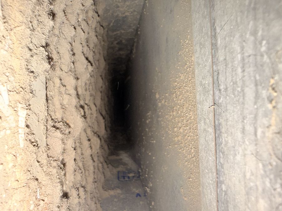 Dust-caked trunk duct on a Westchester job, before cleaning